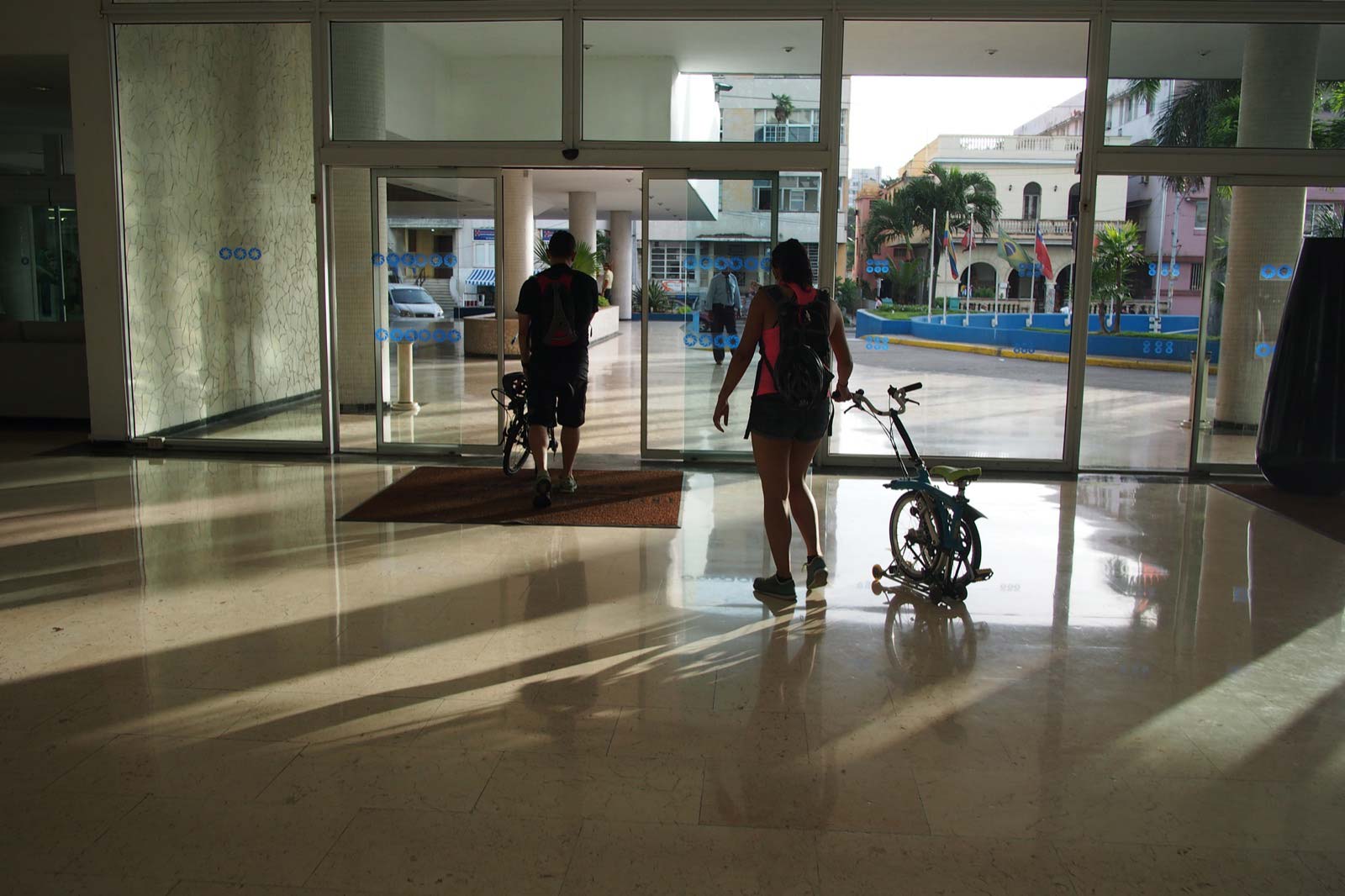 Walking out of a Hotel in La Habana with our Brompton Bicycles